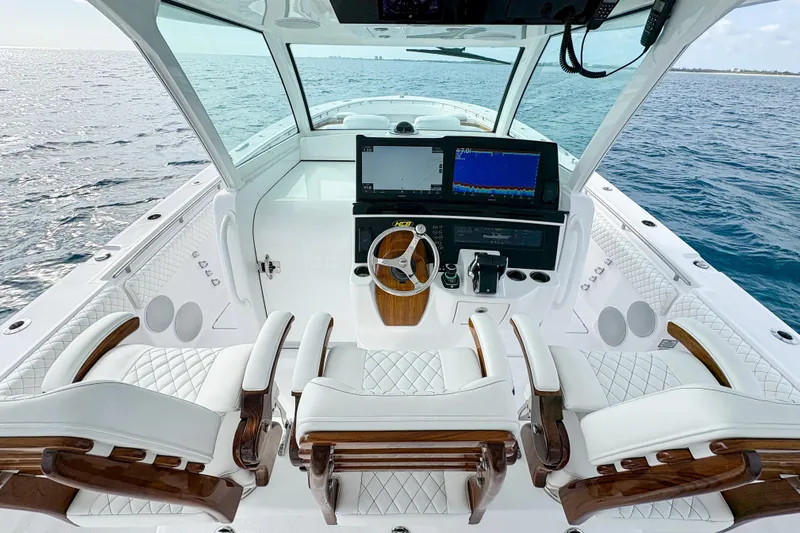  Yacht Photos Pics Luxurious 2026 HCB 48 Campeon boat interior with advanced navigation system and plush seating.