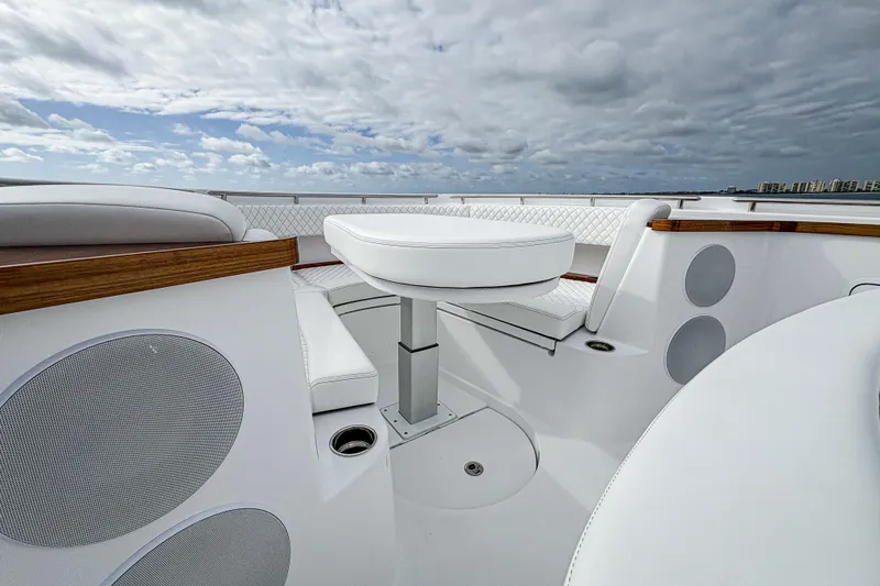  Yacht Photos Pics Luxurious seating area on 2026 HCB 48 Campeon boat under cloudy sky.