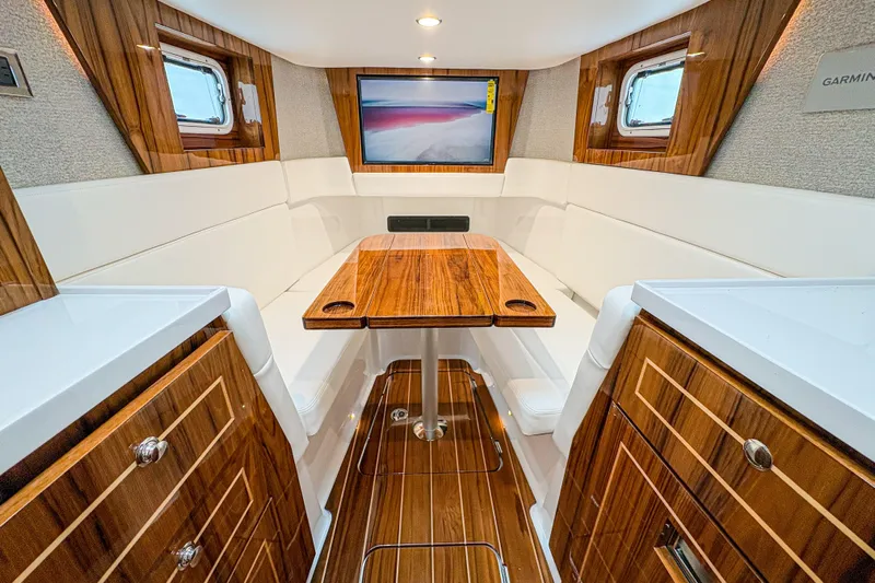  Yacht Photos Pics Luxurious interior of 2026 HCB 48 Campeon yacht with elegant wood finishes and seating.
