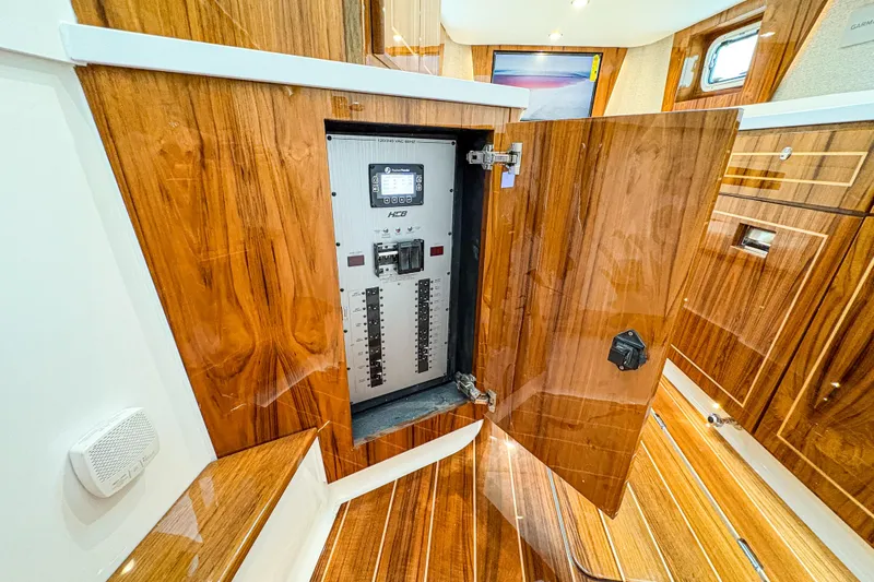  Yacht Photos Pics Electrical panel inside luxurious 2026 HCB 48 Campeon yacht with wooden interior.