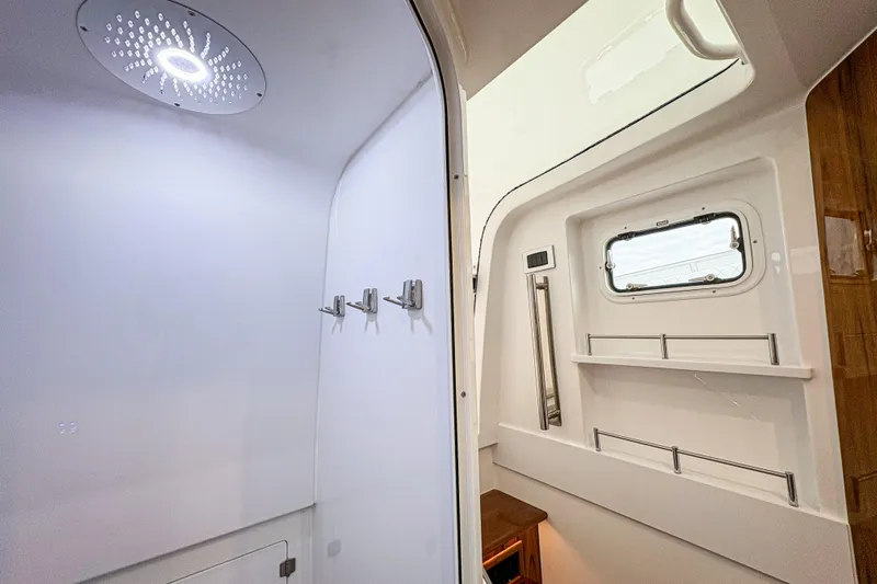  Yacht Photos Pics Interior of 2026 HCB 48 Campeon boat featuring modern shower and window.