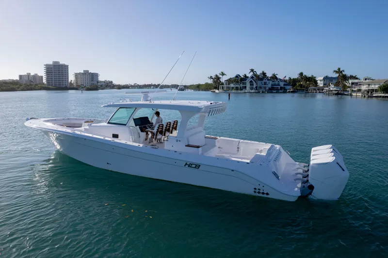  Yacht Photos Pics 2026 HCB 48 Campeon boat on calm water near coastal buildings.
