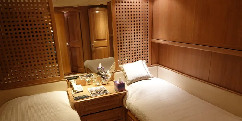 Althea Yacht Photos Pics Luxurious twin cabin interior on 1993 Aegean Yacht Schooner, featuring wooden decor and cozy bedding.