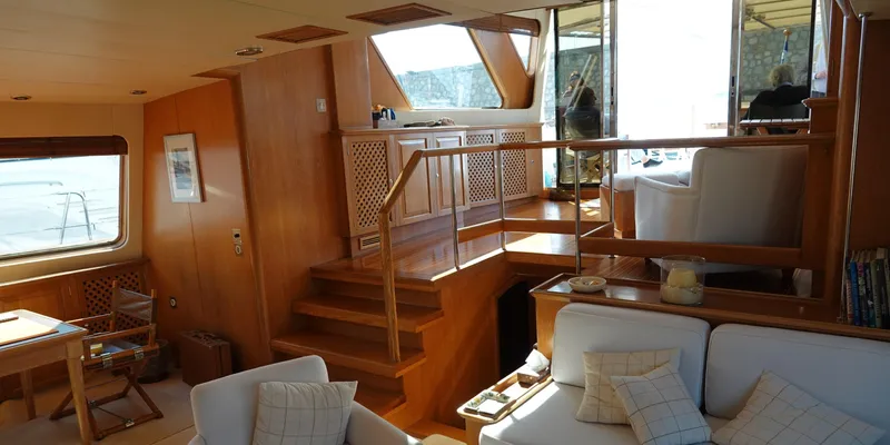 Althea Yacht Photos Pics Luxurious interior of 1993 Aegean Yacht Schooner with wooden finishes and comfortable seating.