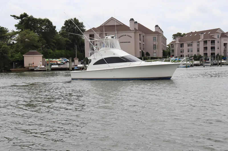  Yacht Photos Pics 2004 Ocean Yachts 43 Super Sport boat docked near waterfront condominiums.