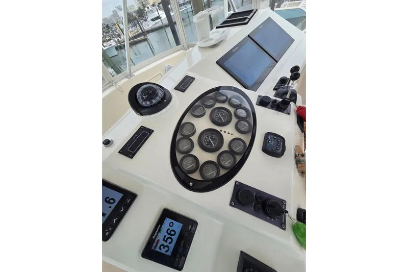 Yacht Photos Pics Helm of 2004 Ocean Yachts 43 Super Sport with navigation instruments and controls.