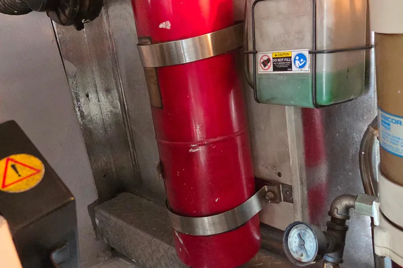  Yacht Photos Pics Engine room of 2004 Ocean Yachts 43 Super Sport with fire extinguisher and gauge.