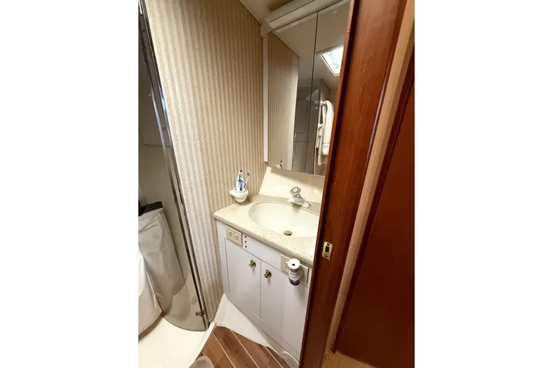  Yacht Photos Pics Bathroom interior of 2004 Ocean Yachts 43 Super Sport with sink and mirror.