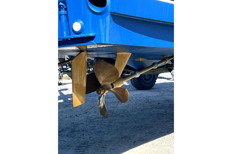  Yacht Photos Pics Propeller and rudder of 2004 Ocean Yachts 43 Super Sport, displayed on dry land.