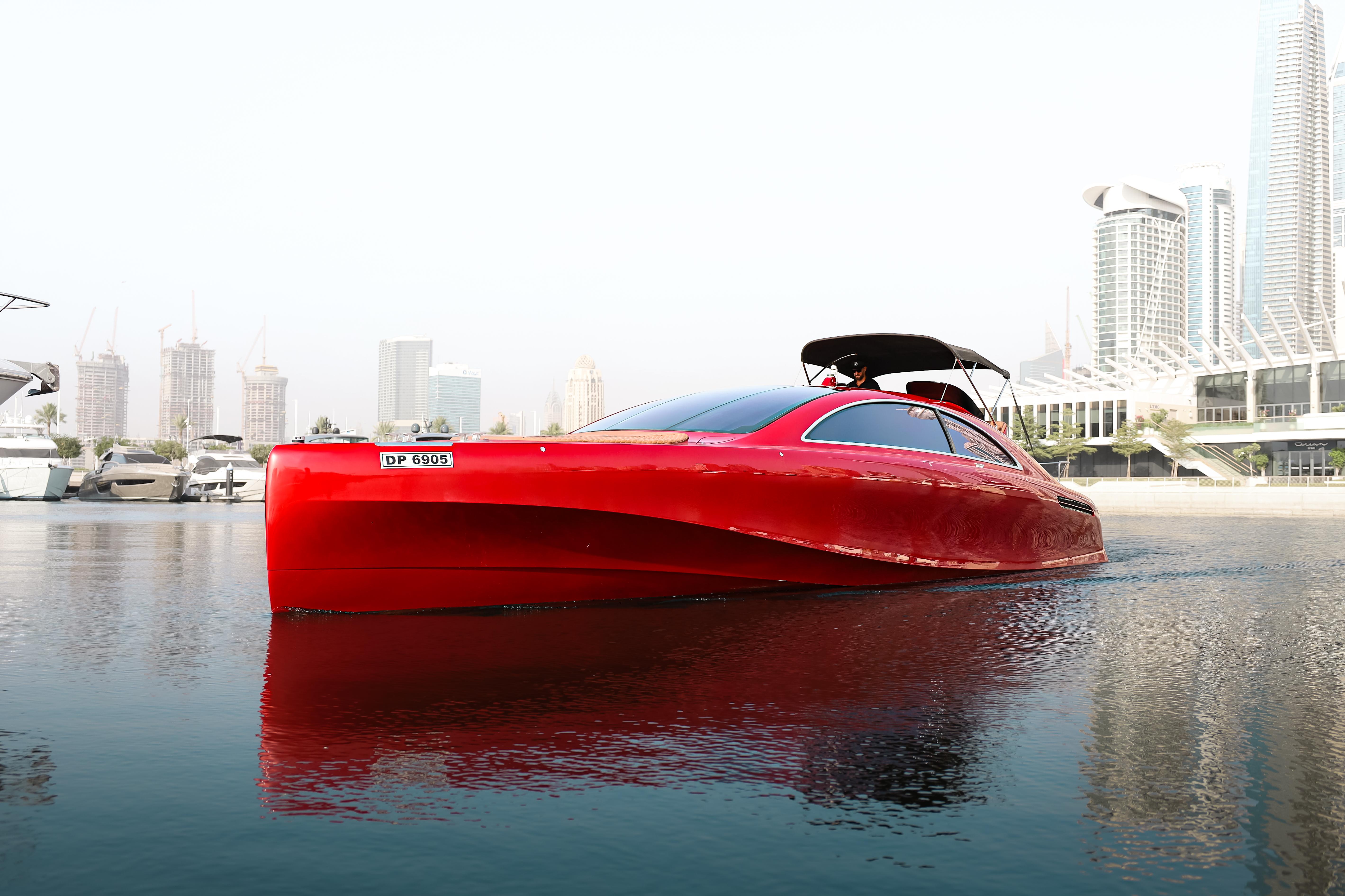 Red 2016 Silver Arrow 460 GT yacht on water, city skyline in background.