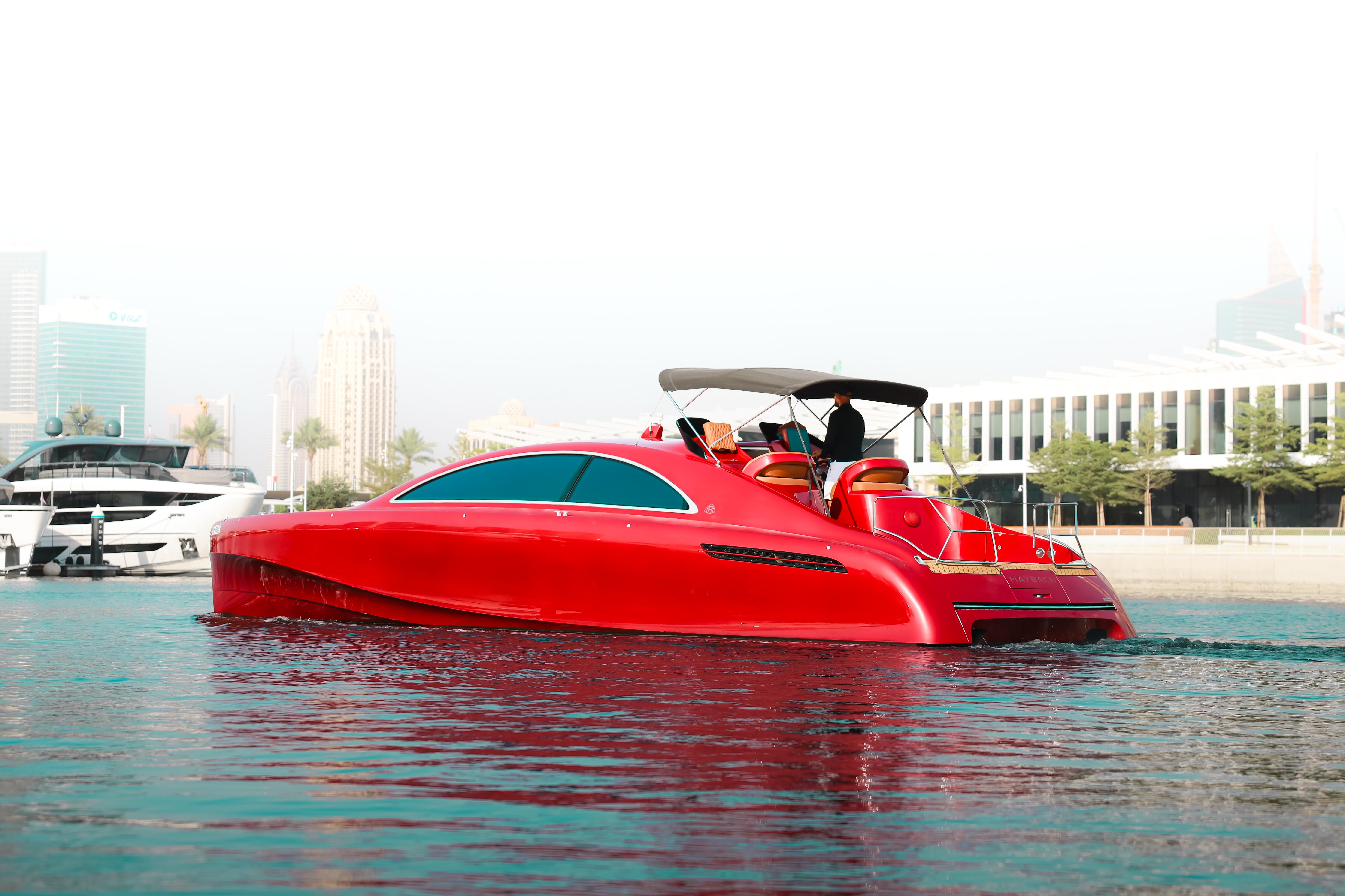 Red 2016 Silver Arrow 460 GT yacht cruising on calm water near modern cityscape.