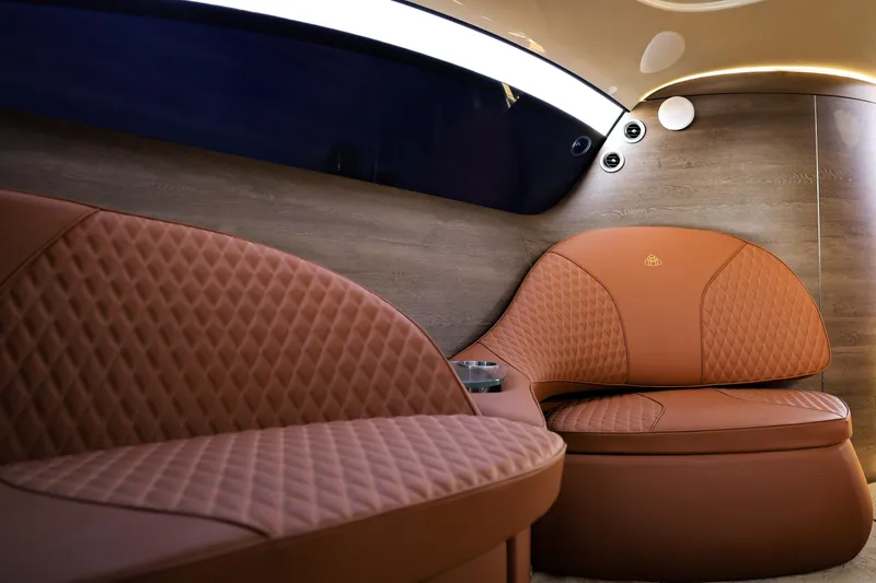 Mercedes Yacht Photos Pics Luxurious interior of 2016 Silver Arrow 460 GT with quilted leather seating and wood paneling.