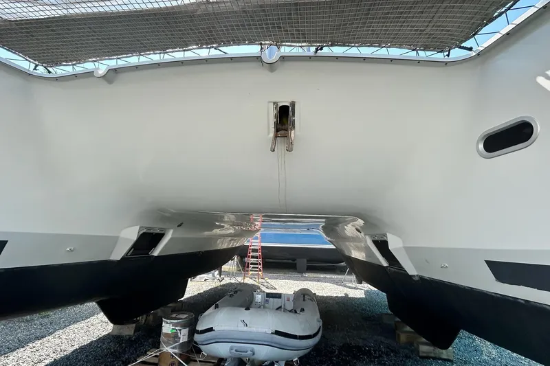  Yacht Photos Pics 2019 Fountaine Pajot Helia 44 Evolution catamaran on dry dock, with inflatable dinghy beneath.