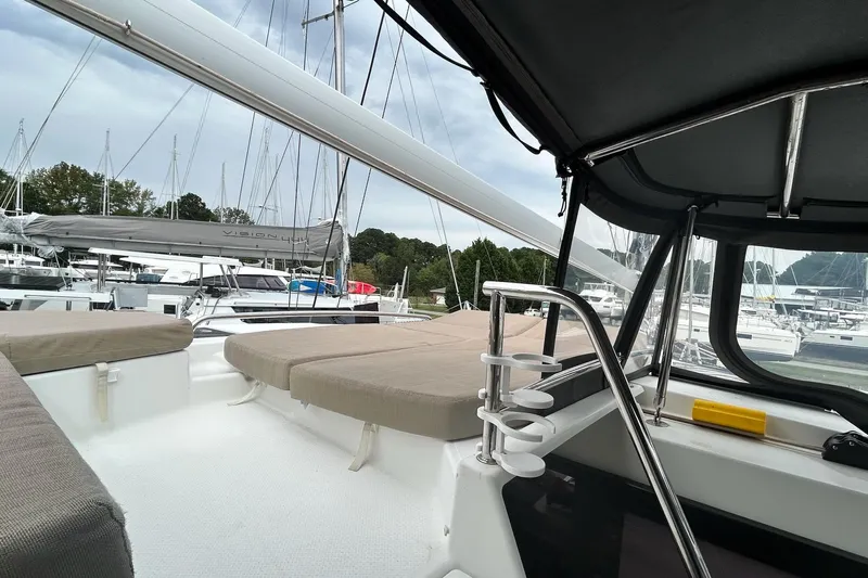  Yacht Photos Pics 2019 Fountaine Pajot Helia 44 Evolution catamaran interior with cushioned seating and marina view.