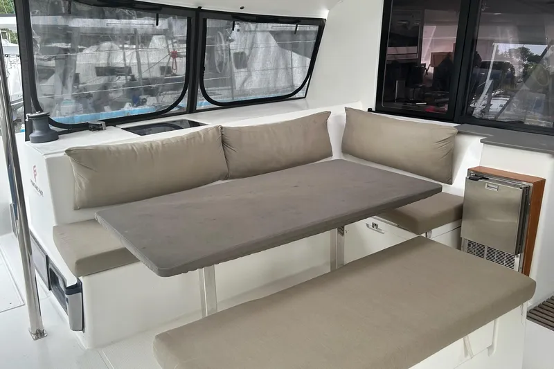  Yacht Photos Pics 2019 Fountaine Pajot Helia 44 Evolution yacht interior with cushioned seating and table.