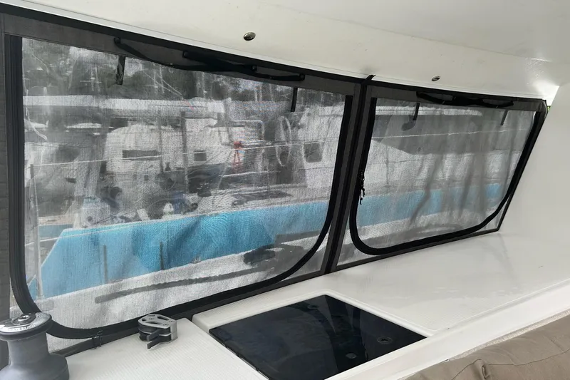  Yacht Photos Pics Interior view of 2019 Fountaine Pajot Helia 44 Evolution catamaran with mesh-covered windows.