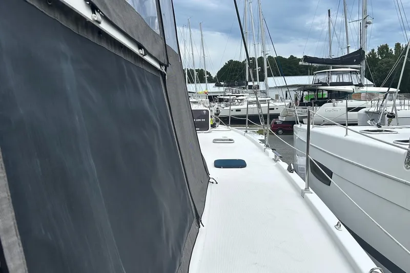 Yacht Photos Pics 2019 Fountaine Pajot Helia 44 Evolution catamaran docked in a marina, surrounded by other boats.
