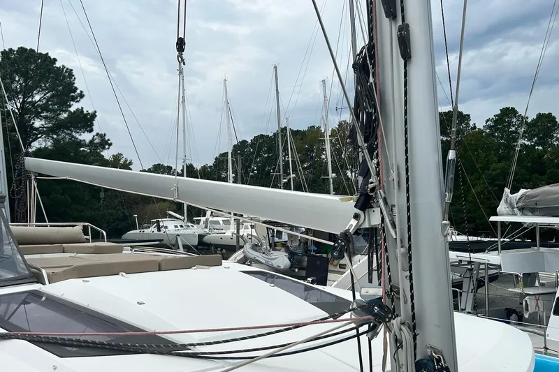  Yacht Photos Pics 2019 Fountaine Pajot Helia 44 Evolution catamaran docked, surrounded by trees and other boats.