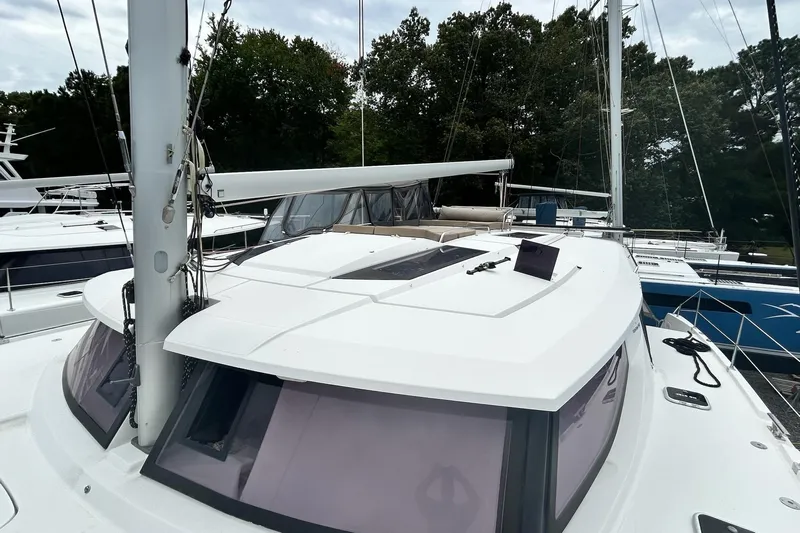  Yacht Photos Pics 2019 Fountaine Pajot Helia 44 Evolution catamaran docked, showcasing sleek design and spacious deck.