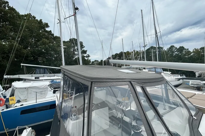  Yacht Photos Pics 2019 Fountaine Pajot Helia 44 Evolution catamaran docked, surrounded by trees and other boats.