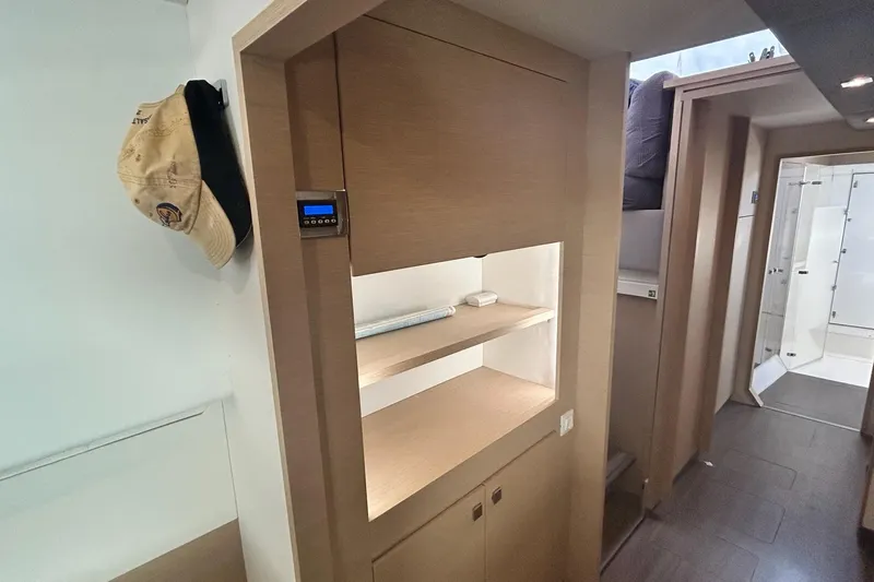  Yacht Photos Pics Interior of 2019 Fountaine Pajot Helia 44 Evolution catamaran, featuring wooden cabinetry and hallway.