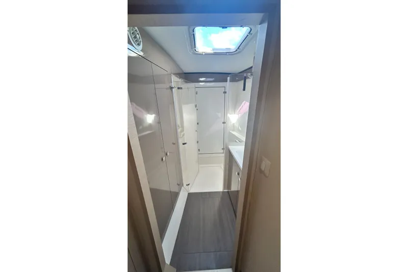  Yacht Photos Pics Bathroom interior of 2019 Fountaine Pajot Helia 44 Evolution catamaran, featuring modern design and skylight.