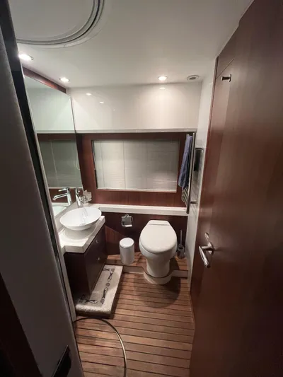  Yacht Photos Pics Luxurious bathroom in 2011 Princess 64 yacht with modern fixtures and wooden flooring.