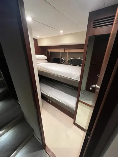  Yacht Photos Pics Interior of 2011 Princess 64 yacht with bunk beds and wooden finishes.