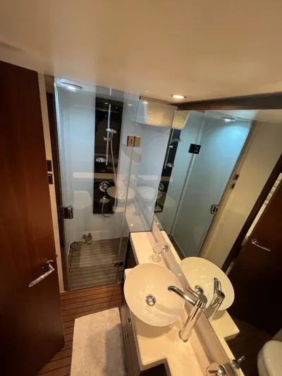  Yacht Photos Pics Luxurious bathroom in 2011 Princess 64 yacht with modern fixtures and glass shower.