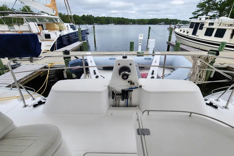 Cinnamon Yacht Photos Pics 2019 Antares 44GT yacht docked at marina, featuring spacious deck and serene water view.
