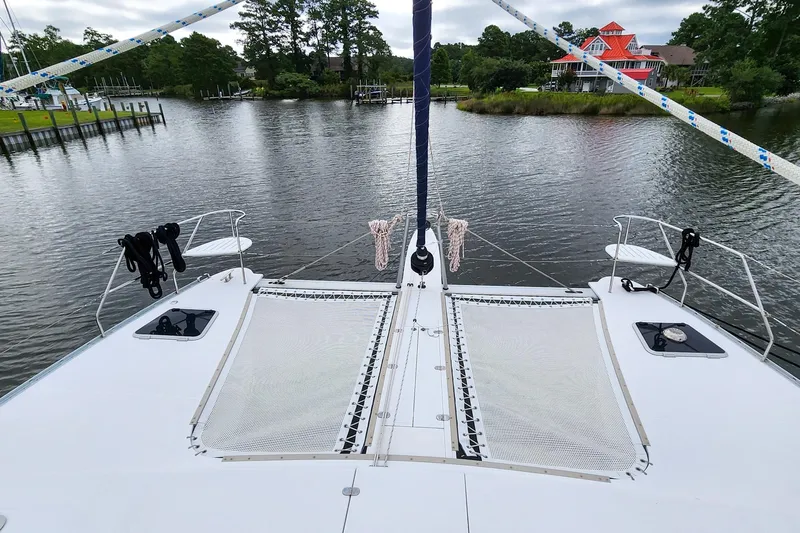 Cinnamon Yacht Photos Pics Front deck of 2019 Antares 44GT catamaran on a serene river.