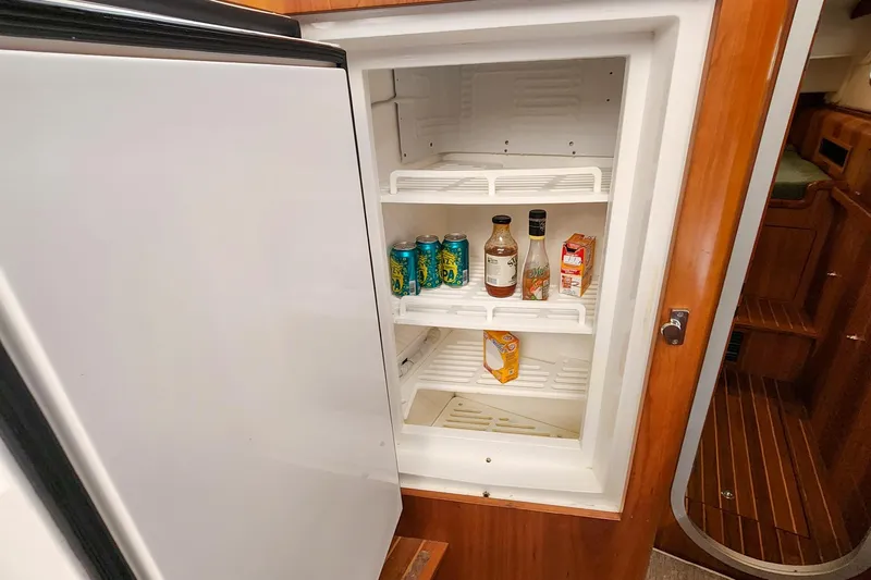 Cinnamon Yacht Photos Pics Open refrigerator in 2019 Antares 44GT yacht with drinks and condiments inside.