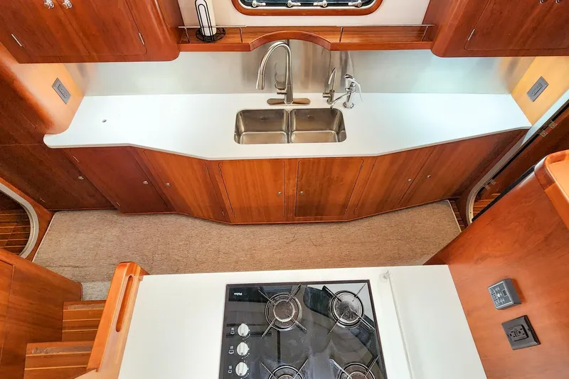 Cinnamon Yacht Photos Pics Modern kitchen interior of 2019 Antares 44GT yacht with stove and sink.