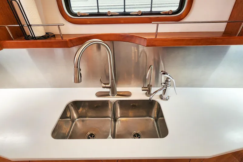 Cinnamon Yacht Photos Pics Modern kitchen sink on 2019 Antares 44GT yacht with stainless steel fixtures.