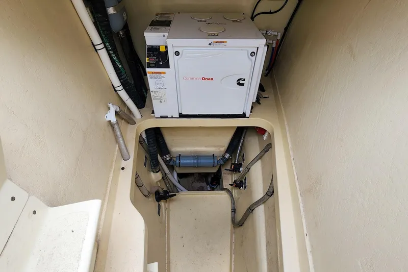Cinnamon Yacht Photos Pics Engine compartment of 2019 Antares 44GT with Cummins Onan generator and visible piping.