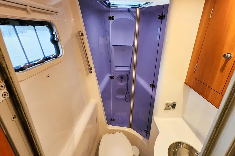 Cinnamon Yacht Photos Pics Modern bathroom in 2019 Antares 44GT yacht with shower, sink, and window.