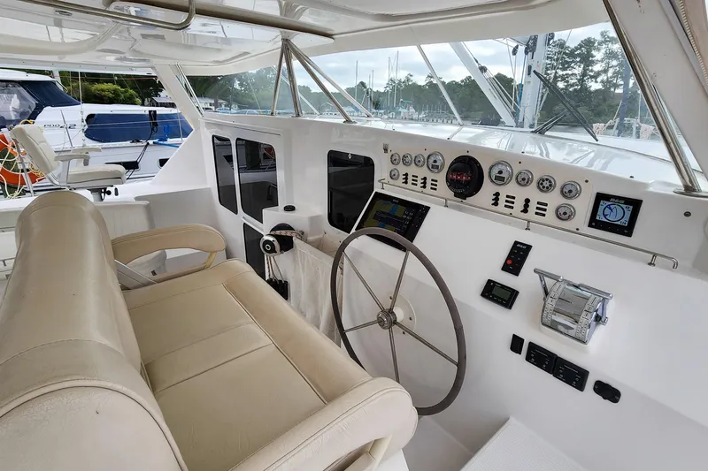Cinnamon Yacht Photos Pics Helm of 2019 Antares 44GT yacht with steering wheel and control panel.