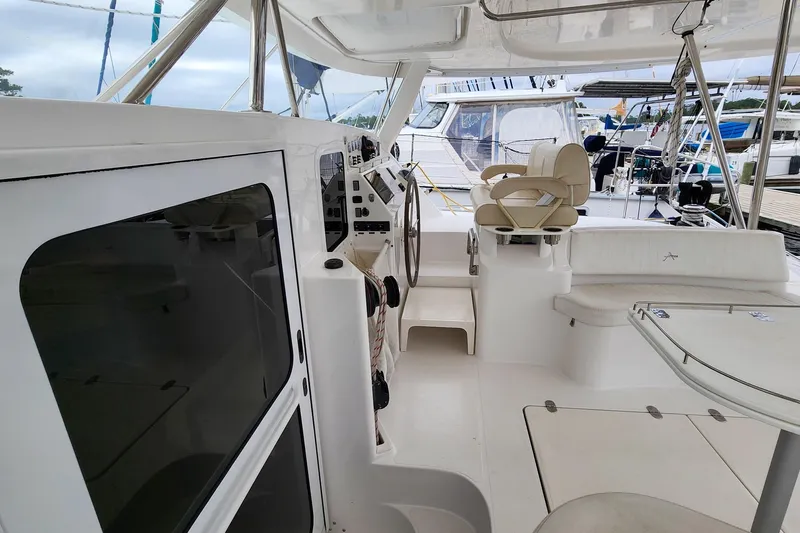 Cinnamon Yacht Photos Pics 2019 Antares 44GT yacht cockpit with steering wheel and seating area.