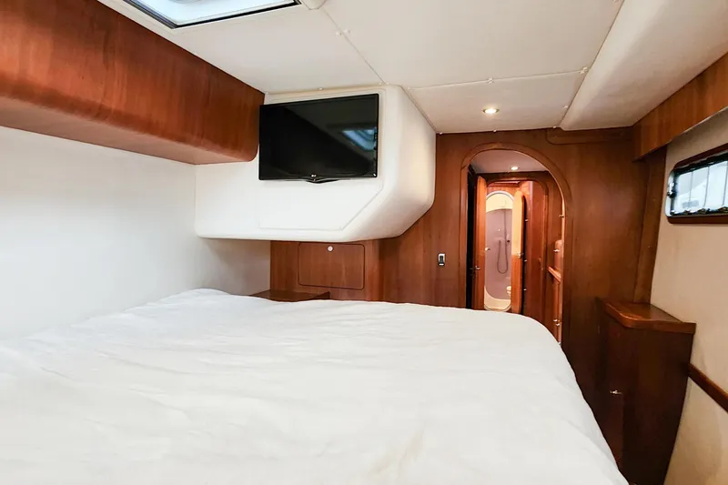 Cinnamon Yacht Photos Pics Luxurious cabin interior of 2019 Antares 44GT yacht with wood finish and TV.