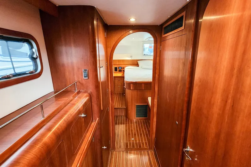 Cinnamon Yacht Photos Pics Luxurious wooden interior of 2019 Antares 44GT yacht cabin with bed and window.