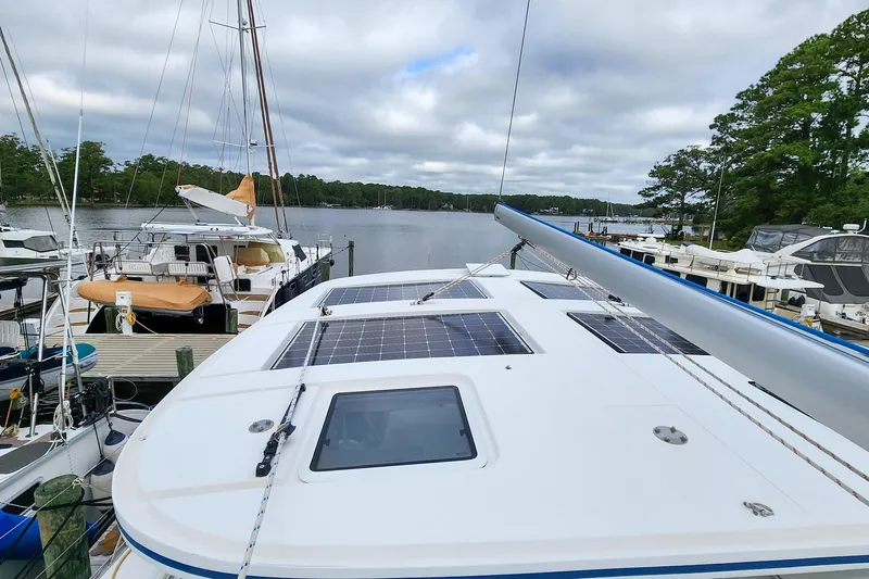 Cinnamon Yacht Photos Pics Sailboat Antares 44GT 2019 docked, featuring solar panels on deck, surrounded by other boats.