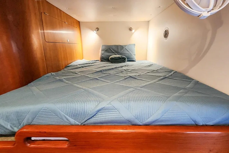 Cinnamon Yacht Photos Pics Cozy cabin bed in 2019 Antares 44GT yacht with wooden accents and soft lighting.