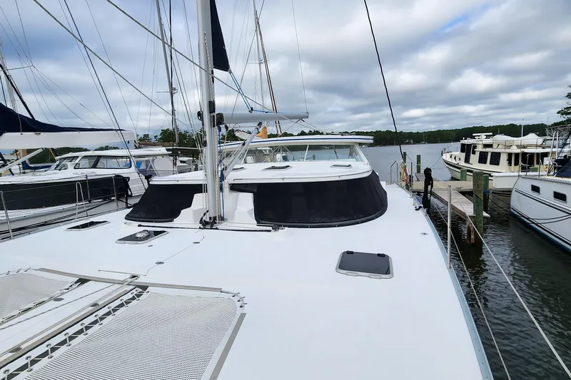 Cinnamon Yacht Photos Pics 2019 Antares 44GT yacht docked at marina, surrounded by other boats.