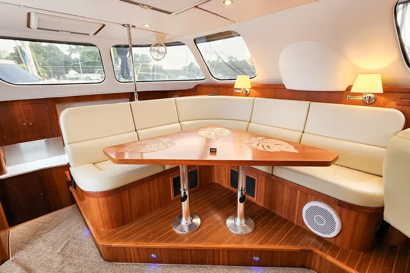 Cinnamon Yacht Photos Pics Luxurious interior of 2019 Antares 44GT yacht with elegant seating and wooden table.