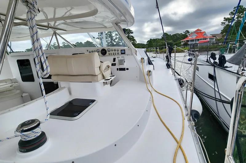 Cinnamon Yacht Photos Pics 2019 Antares 44GT yacht deck with helm, moored by waterfront homes.