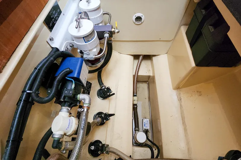 Cinnamon Yacht Photos Pics Engine compartment of 2019 Antares 44GT yacht, showcasing mechanical components and piping.