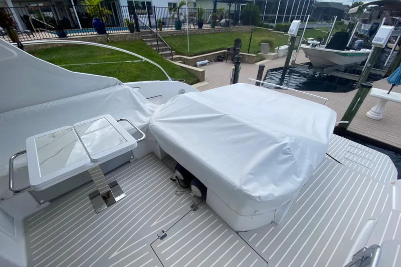  Yacht Photos Pics Azimut Atlantis 45 yacht deck, 2021 model, featuring covered seating and table.