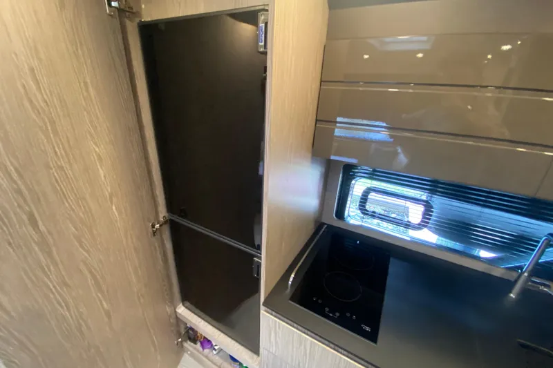  Yacht Photos Pics Modern kitchen interior of 2021 Azimut Atlantis 45 yacht with sleek cabinetry and appliances.