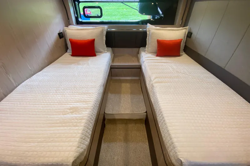 Yacht Photos Pics Twin beds with white bedding and orange pillows in 2021 Azimut Atlantis 45 yacht cabin.