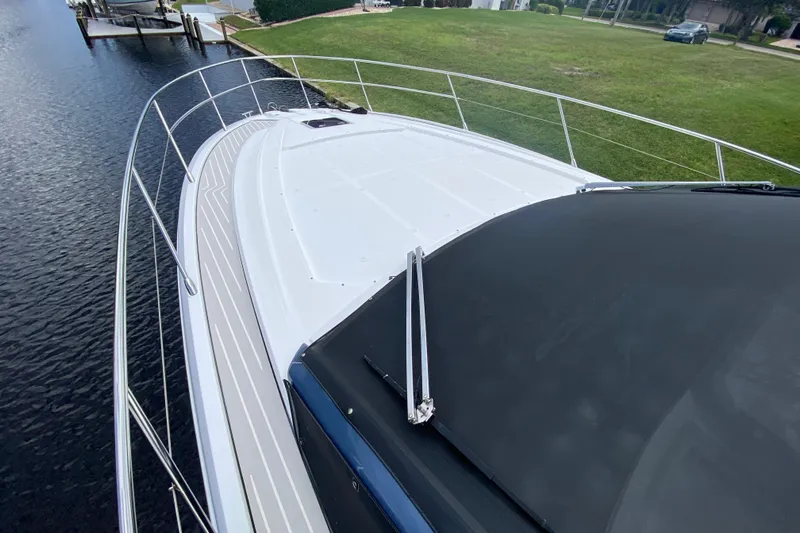  Yacht Photos Pics Azimut Atlantis 45 yacht deck, 2021 model, docked by a grassy shoreline.